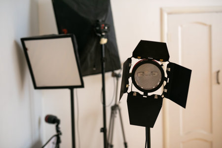Photography studio flash on a lighting stand on white background with lamp. Proffetional equipment...