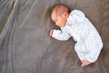 Baby boy sleeping first days of life. Cute little newborn child sleeping peacefully.