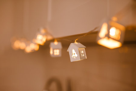 Christmas garland in the form of glowing white houses. New Year's concept.の写真素材