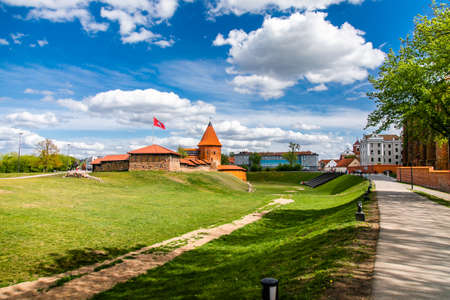 Historical gothic Kaunas Castle from medieval times in Kaunas, Lithuania. Wide angle panoramic view on cloudy sky background.のeditorial素材