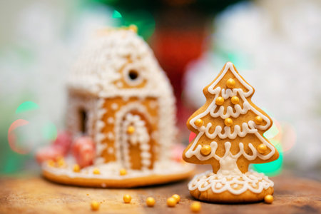 Gingerbread house made of gingerbread cookies decorated with icing, caramel, candy, decorative...