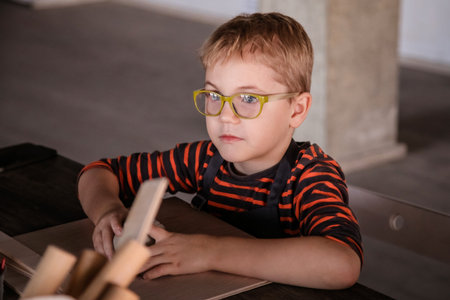 Handmade Ceramics: Special 5-Year-Old Boy with Glasses at Work.
