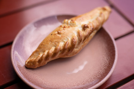 Kibinai, traditional Lithuanian food, pastries filled with sweet cottage cheese, popular with Karaite ethnic minority in Trakai, Lithuania. Red background.の写真素材