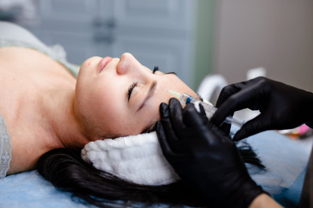 Woman Receiving Skin-Enhancing Cosmetic Treatments at Beauty Salon.