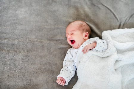 Close-up portrait of adorable baby boy sleeping in bedの写真素材