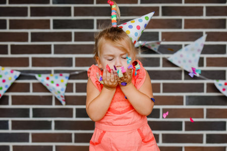 Cute preschooler girl makes art at a summer outdoor party.の写真素材