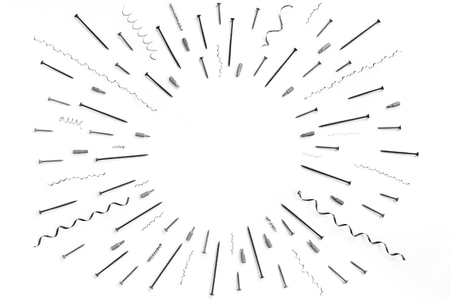 Pattern of screws, nails, metal shavings, bits for a screwdriver with circle place for text in the middleの写真素材