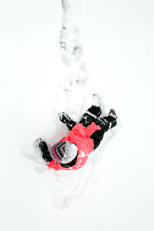 The child fell into the snow. Top viewの写真素材