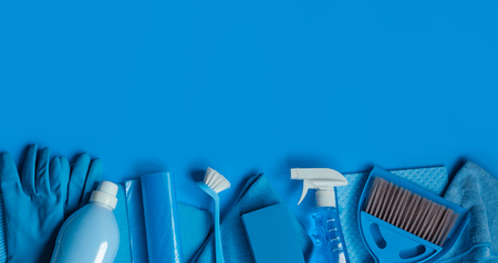 Blue set of tools and cleaning tools for spring cleaning in the house on a blue background. Place for text.の写真素材