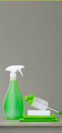 Green set of cleaning products and tools for spring cleaning.