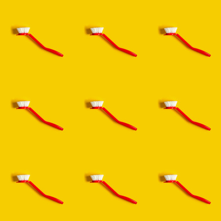 Bright red brush lies on a bright yellow background. In the style of pop art. Top view. Copy space.の写真素材