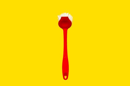 Bright red brush lies on a bright yellow background. In the style of pop art. Top view. Copy space.の写真素材