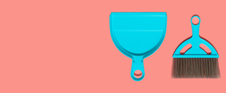 A pale blue dustpan and brush lying on living coral background. In the style of pop art. Top view.の写真素材