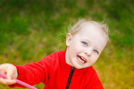 Portrait of a beautiful white baby girl who plays with butterfly net. Lifestyle.の写真素材