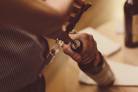SAINT PETERSBURG, RUSSIAN FEDERATION - AUG 16 2018: man uncorks a bottles of wine. Prepares wine for sommeliers training.のeditorial素材