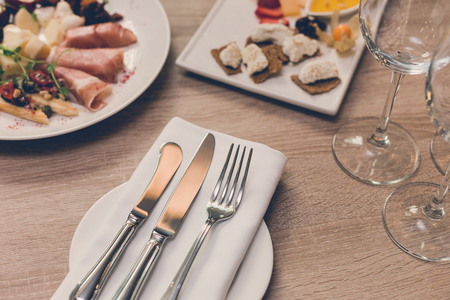 Table in the restaurant with appetizer, Cutlery and glassesの写真素材