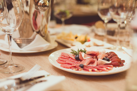Table in the restaurant with appetizer, Cutlery and glassesの写真素材