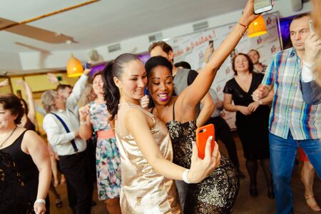 Moscow, Russia-January 19, 2019: people of different races dance in the club and broadcast the partyのeditorial素材
