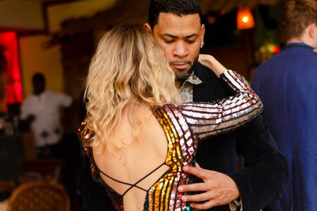 Moscow, Russia-January 19, 2019: A middle-aged couple, a man and a woman, dance salsa among a crowd of dancing people in a nightclub Tiki bar.のeditorial素材