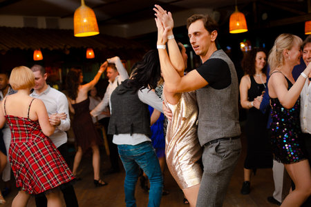Moscow, Russia-January 19, 2019: A middle-aged couple, a man and a woman, dance salsa among a crowd...