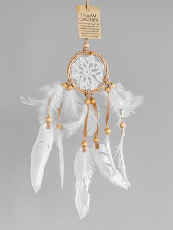 White dreamcatcher - Indian amulet that protects the sleeper from evil spirits and diseases. Card with instructions.の写真素材