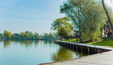 The deserted shore of the pond of the country hotel spring-summer 2020. Concept of the coronovirus epidemic. The collapse of the tourist business.の写真素材
