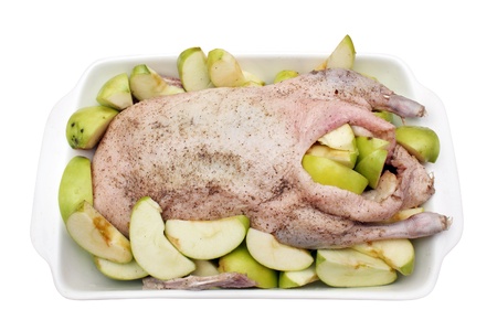 raw duck with green apples ready for roasting isolatedの写真素材
