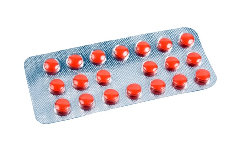 multicolored pills on pack isolated on white backgroundの写真素材