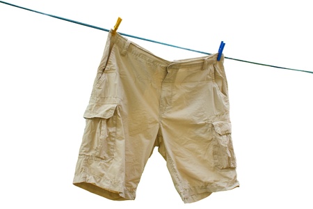 beige cargo shorts hanged up with clothespegsの写真素材