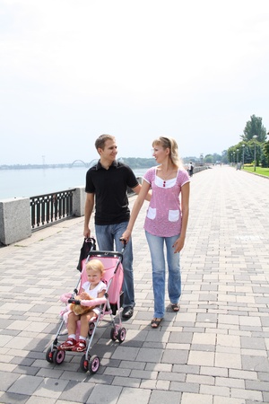 family walking on embankment looking at the riverの写真素材