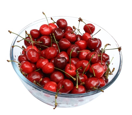 sweet cherries in glass plate isolated on whiteの写真素材