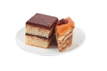two pieces of different cake on one plate isolated over whiteの写真素材