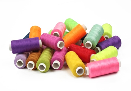few nice colorful bobbins on white backgroundの写真素材
