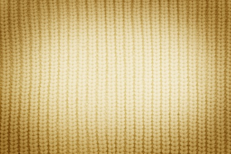 cream sweater knitted textured background with vingette close upの写真素材