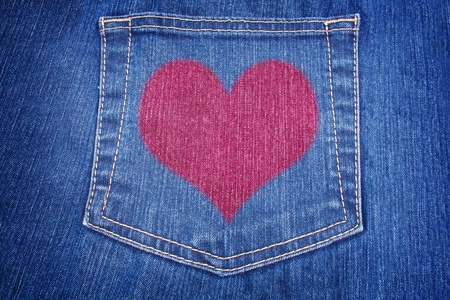 blue jeans pocket with read heart on it close up textile textureの写真素材