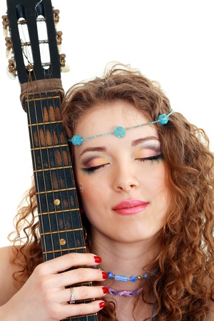 Beautiful Girl holding guitar on white background in hippie outfit isolatedの写真素材