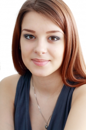 Portrait of trendy young woman in funky dark blue dress against white background. focus on eyesの写真素材