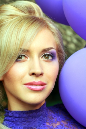Beautiful Young Woman Face with violet make up looking to the cameraの写真素材