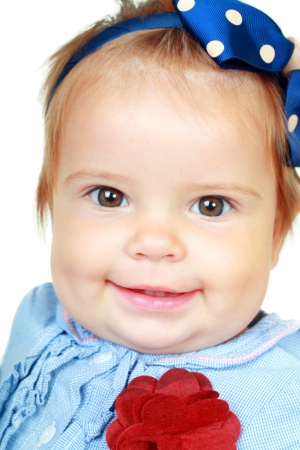 Close up beautiful 10 month old baby girl isolated on whiteの写真素材