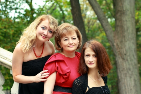A portrait of a mother and her daughters in the parkの写真素材