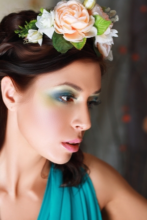 Beautiful girl with stylish makeup and flowers around her.の写真素材