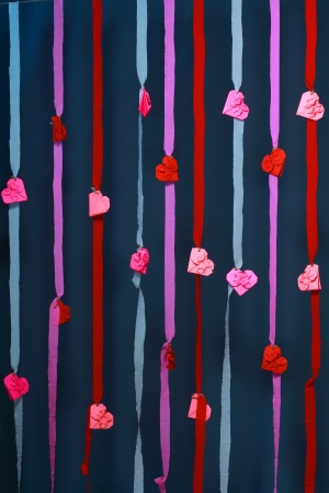 handmade abstract studio valentine day background  with paper stripes and origami heartsの写真素材