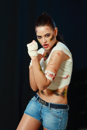 camo girl female fighter looking agressive over dark backgroundの写真素材