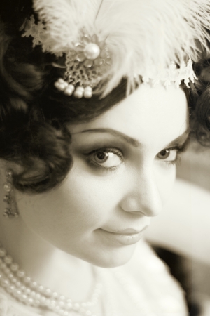 Beautiful young woman close up portrait in retro flapper style headband bw Vogue style vintageの写真素材