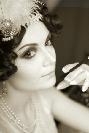 Beautiful young woman close up portrait in retro flapper style headband bw Vogue style vintageの写真素材