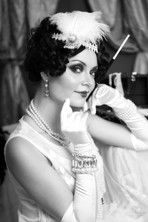 Beautiful young woman close up portrait in retro flapper style headband bw Vogue style vintageの写真素材