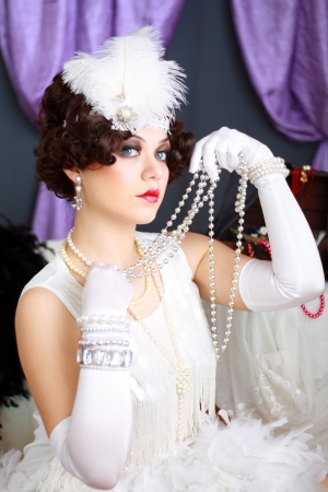 Beautiful young woman portrait in retro flapper style headband Vogue style vintageの写真素材