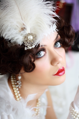 Beautiful young woman portrait in retro flapper style headband Vogue style vintageの写真素材