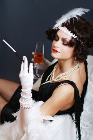 Beautiful young woman close up portrait in retro flapper style Vogue style vintageの写真素材