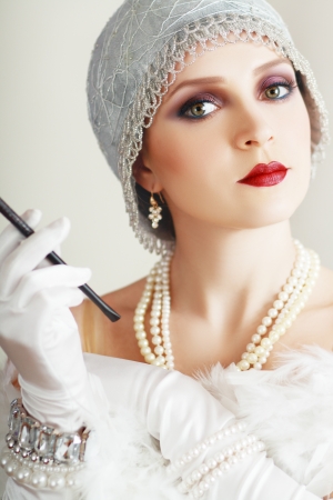 Beautiful young woman close up portrait in retro flapper style headband Vogue style vintageの写真素材